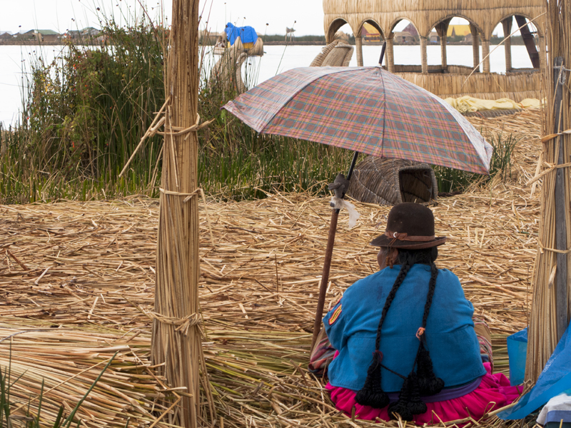 Peru Puno Titicaca ferry Uros island traditional clothes umbrella