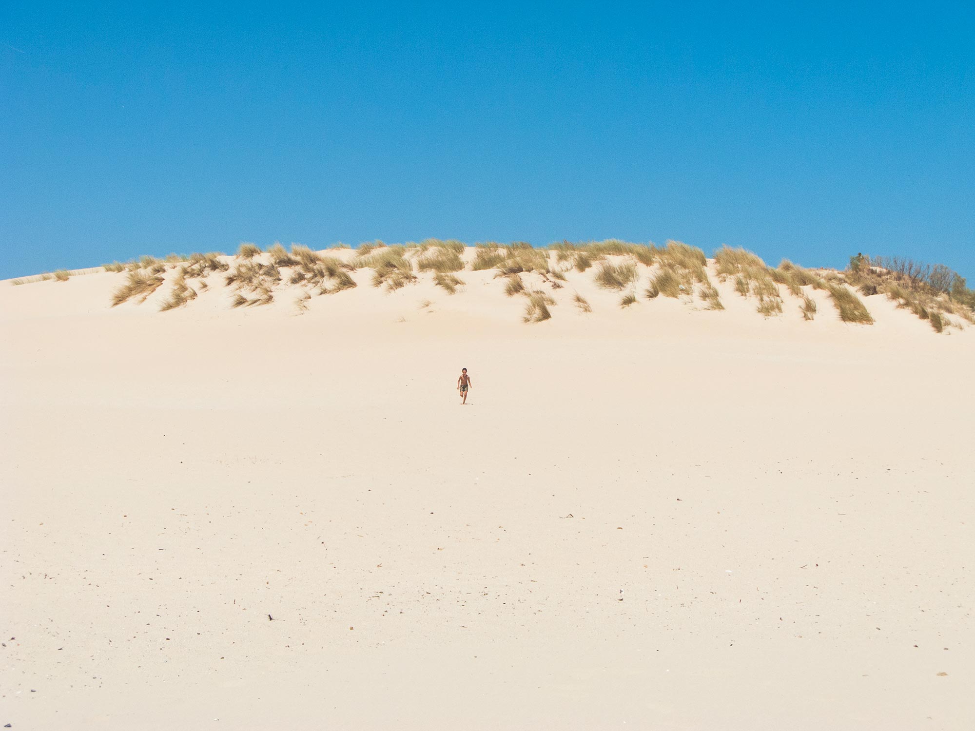 valdevaqueros beach kid running on a dune